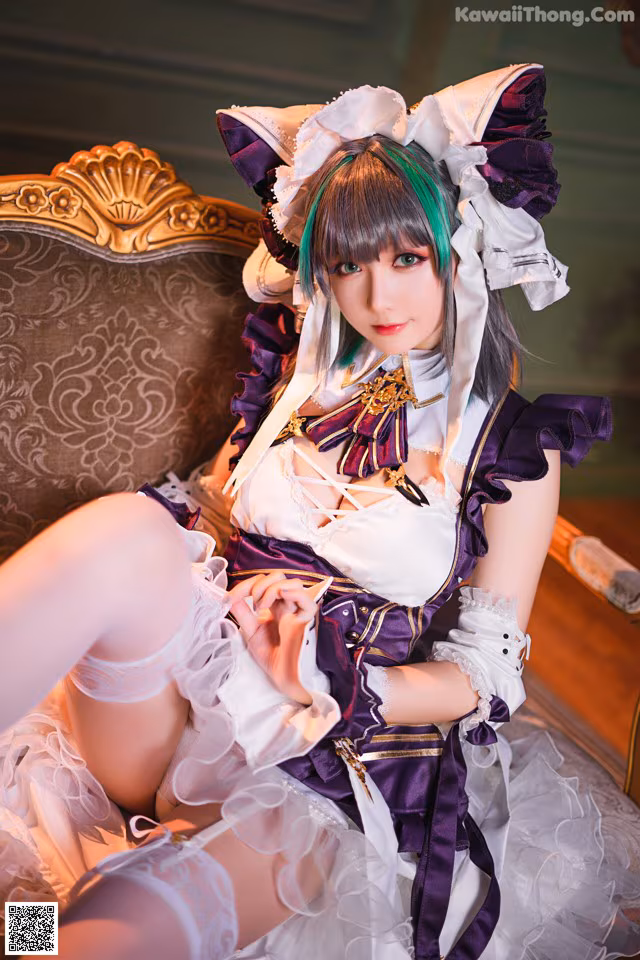 A woman in a maid outfit sitting on a couch.