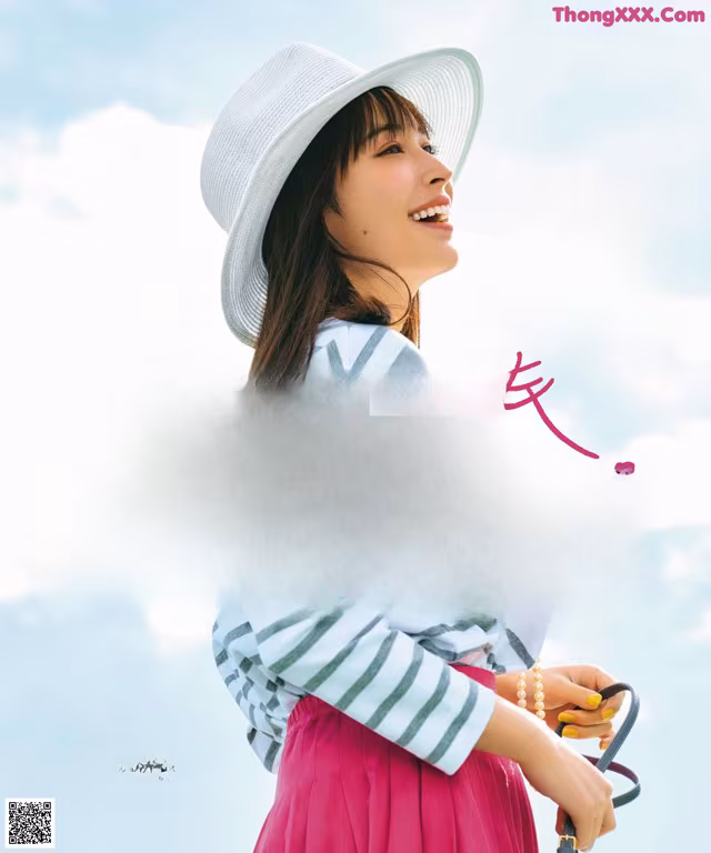 A woman wearing a white hat and a pink skirt.