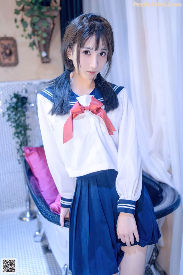 A woman in a school uniform posing for a picture.