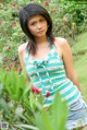 A young woman standing in a field of flowers.