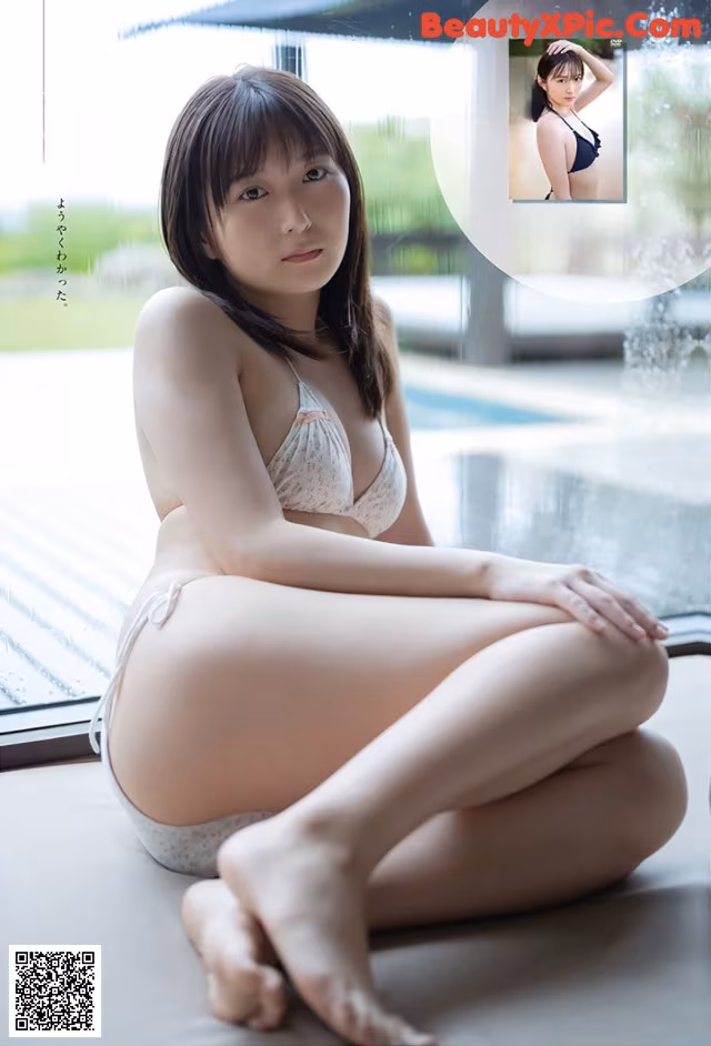 A woman in a white bikini sitting on a window sill.