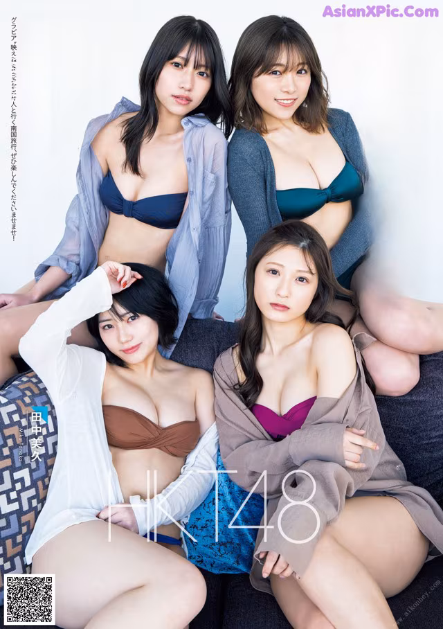 A group of three women sitting on top of a couch.