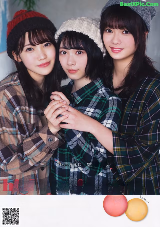 A group of three young women standing next to each other.