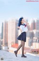 A woman in a school uniform is posing for a picture.