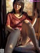 A woman sitting on a window sill with her legs crossed.